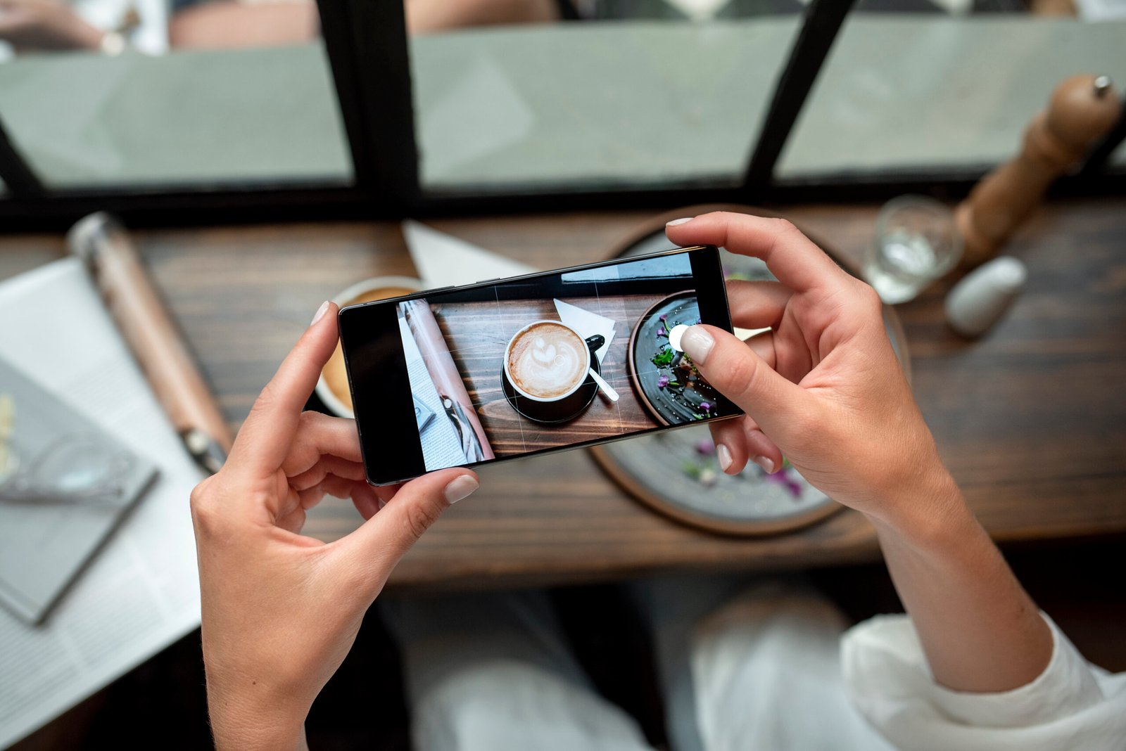 close up hands taking coffee photos - CompareNow