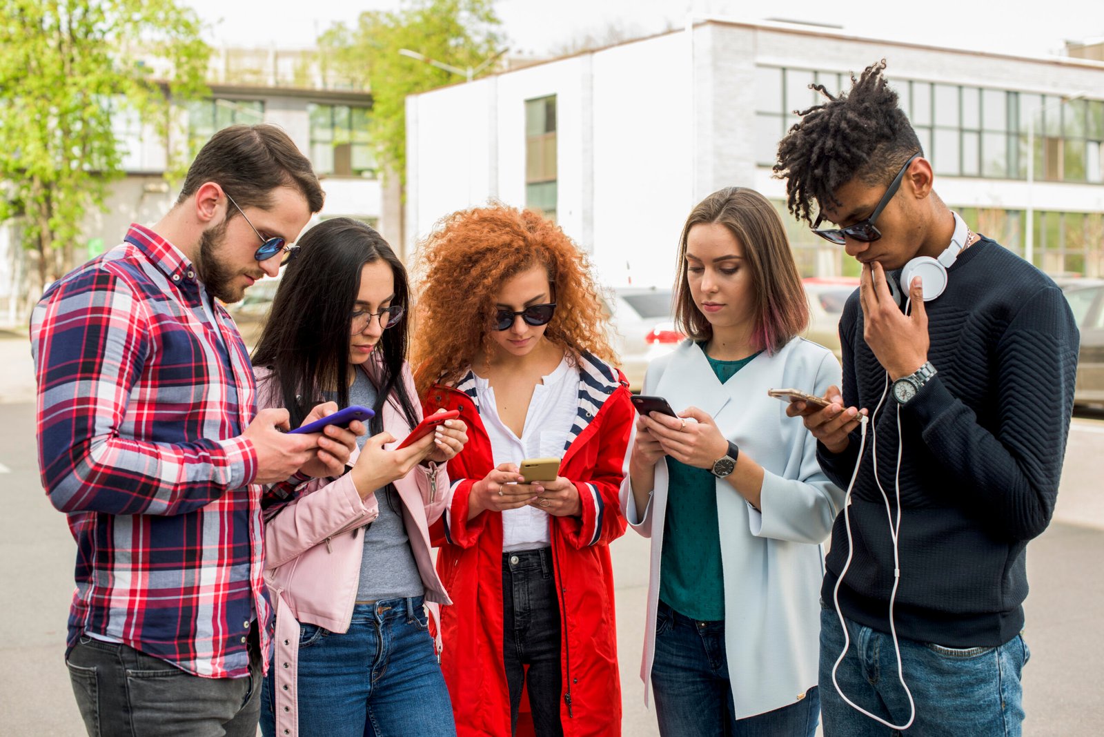 group-modern-friends-using-cellphone-outdoors