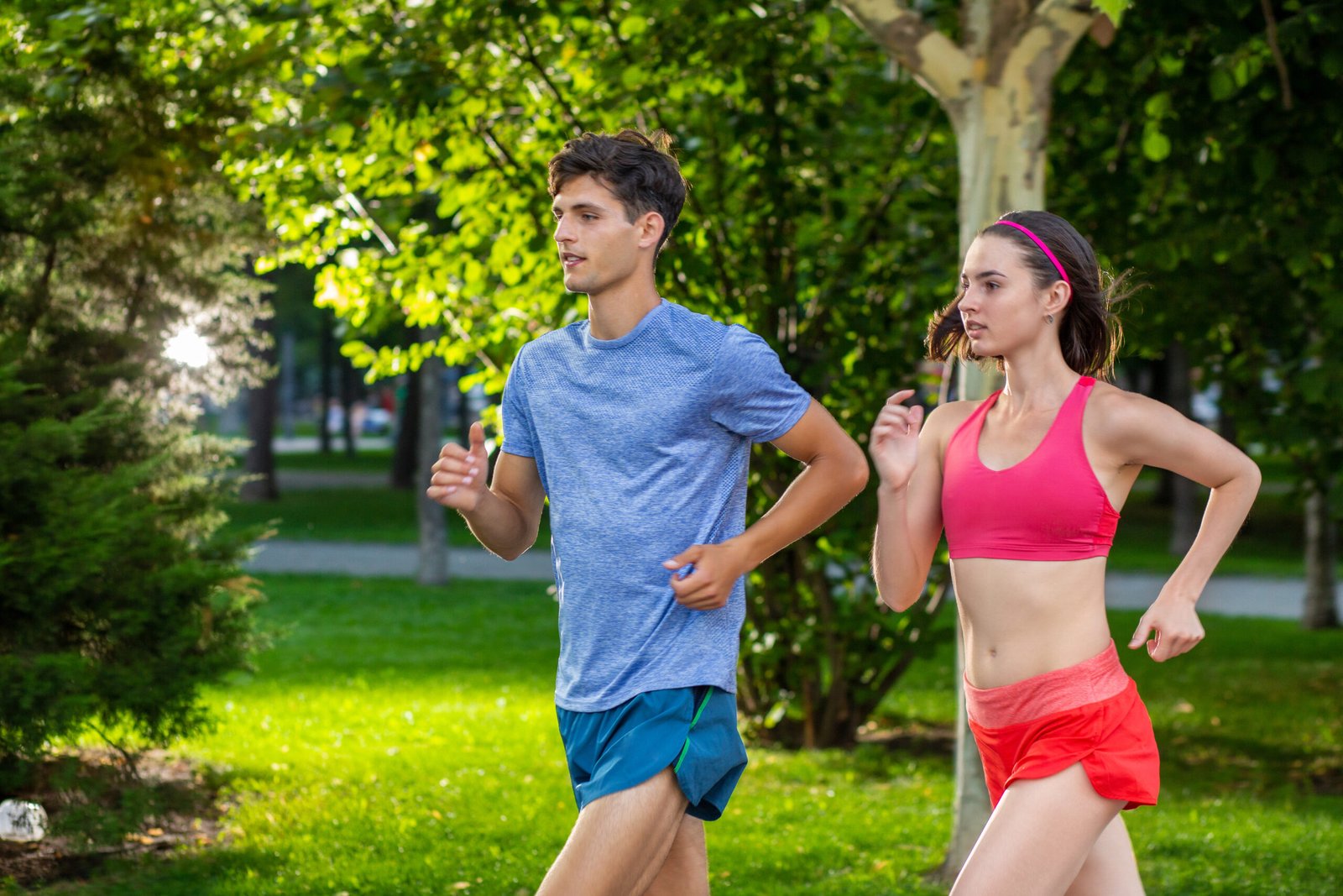 Portrait of cheerful caucasian couple running outdoors